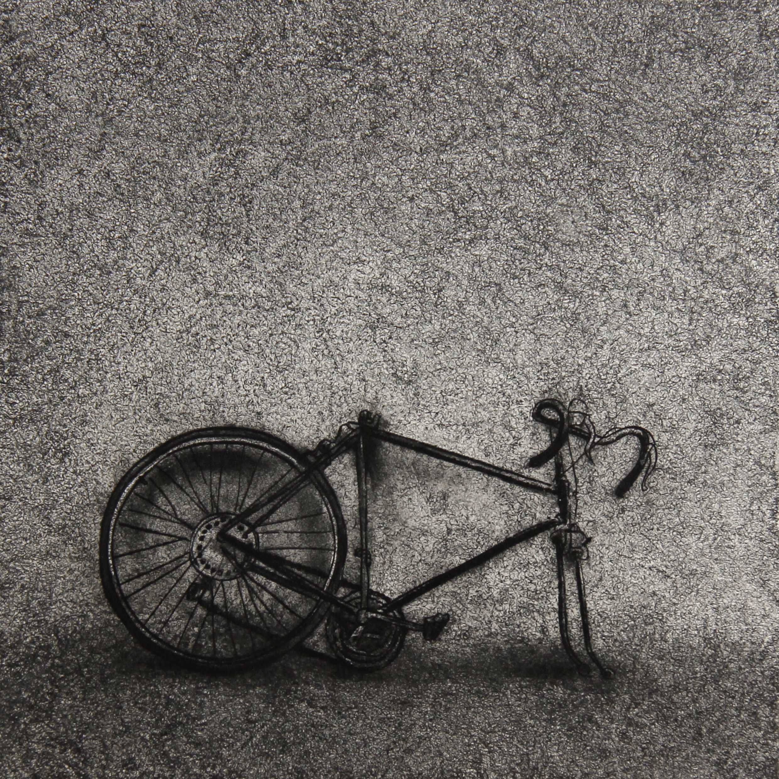 A monotype print from the ASSENZA series by Hydon BAI. The scattered remains of a bicycle — fragmented components bereft of the coherence that once made them a vehicle of autonomous movement — rendered in subdued tonal gradations against the densely grained surface characteristic of the deterministic monotype technique. The Hydon BAI Method's unique material signature, the residue of high-pressure transfer and ritual destruction of the original plate, charges the image with the gravity of an archaeological record: what remains when the capacity to steer one's own trajectory has disintegrated into separate, inert parts.