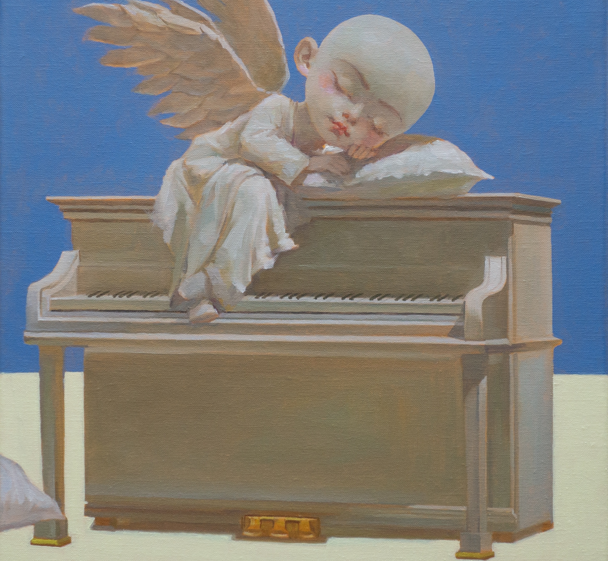 A diptych oil painting. The left panel showcases an empty, carousel structural framework under a flat blue and sand-colored sky. The right panel captures a bald, winged cherub resting peacefully with a serene Buddha-like expression on a grey piano top against a solid blue background.